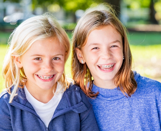 Girls smiling with braces at Gardner & La Rochelle Orthodontics in Richmond, VA
